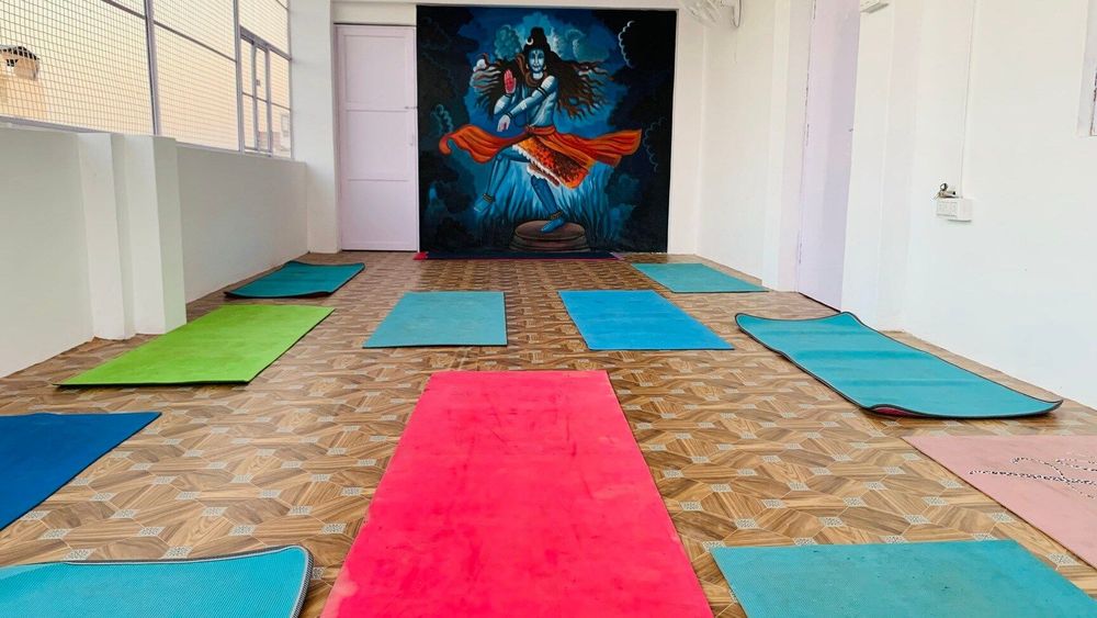 Yoga instructor guiding a private beginner or advanced class near Dashashwamedh Ghat