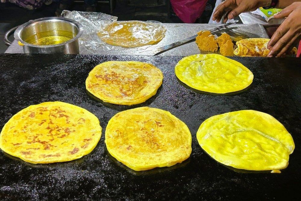 Holige, lassi and local desserts served during a Bangalore street food tasting walk