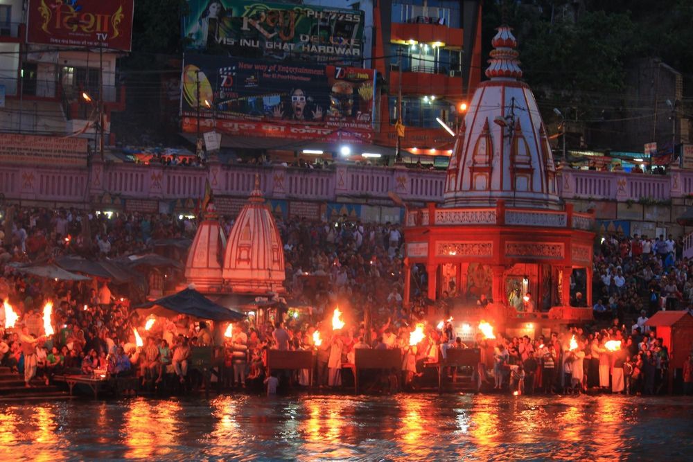Priests performing evening Ganga Aarti at Har Ki Pauri during a Haridwar tour
