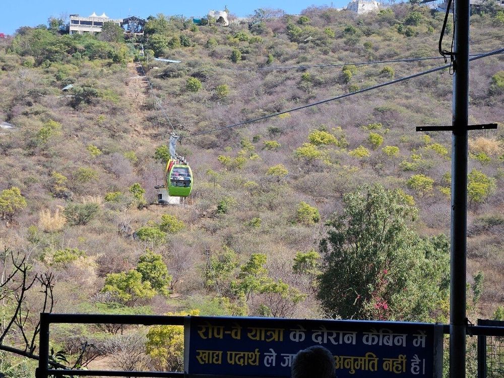 Visitors walking from the upper ropeway station toward Karni Mata Temple in Udaipur