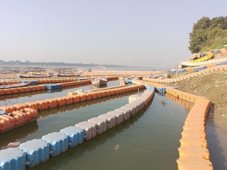 Pilgrim boats and water birds around the Triveni Sangam meeting point in Prayagraj
