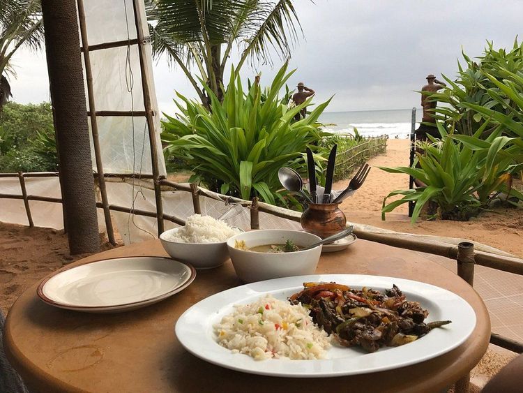 Outdoor garden tables facing Calangute Beach at Pousada by the Beach Goa