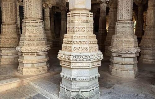 Detailed marble pillars inside Ranakpur Jain Temple during a guided heritage visit
